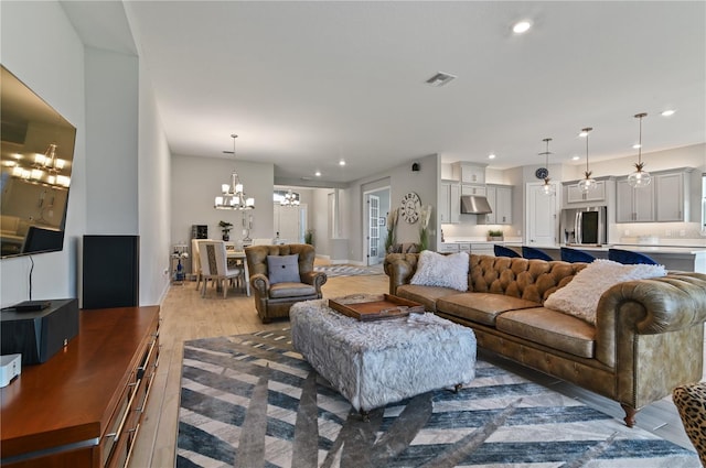 living room featuring hardwood / wood-style flooring and a notable chandelier