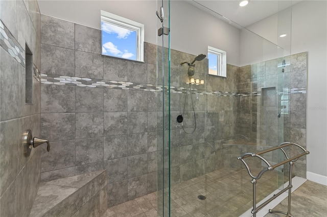 bathroom featuring a tile shower and plenty of natural light