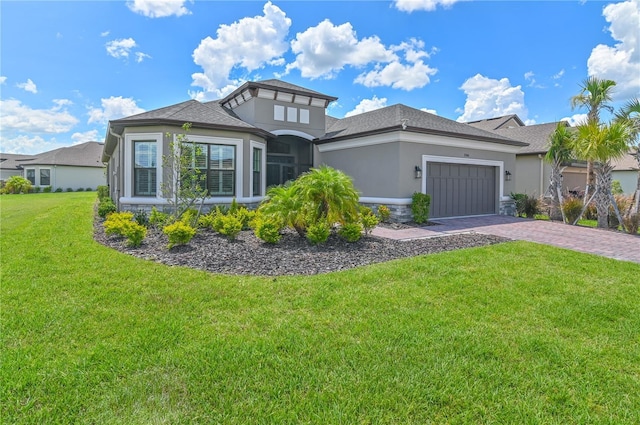 prairie-style home featuring a garage and a front lawn