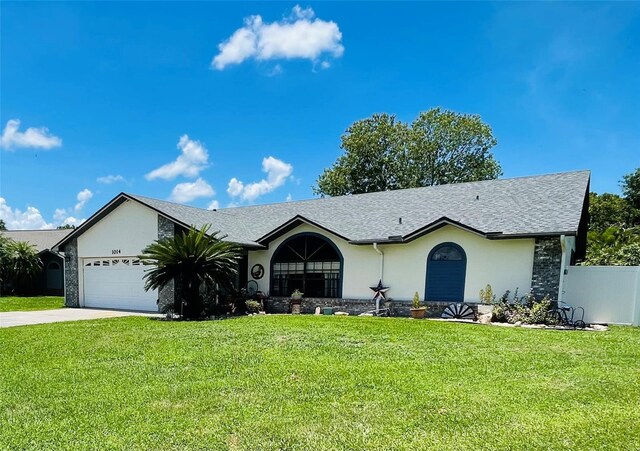 single story home with a garage and a front yard