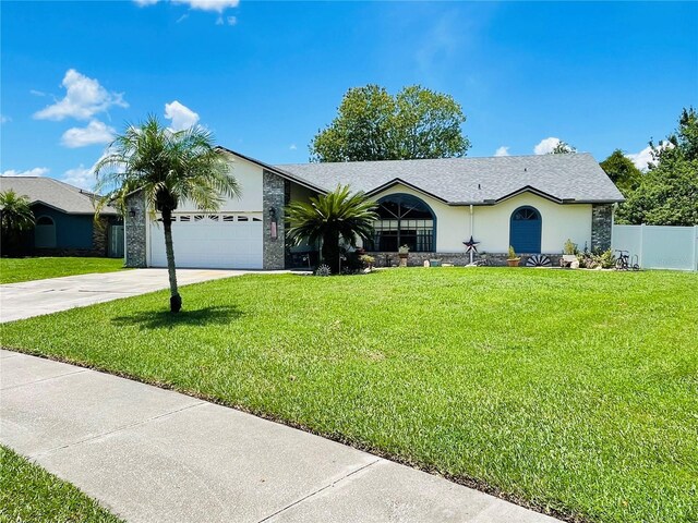 single story home with a garage and a front yard