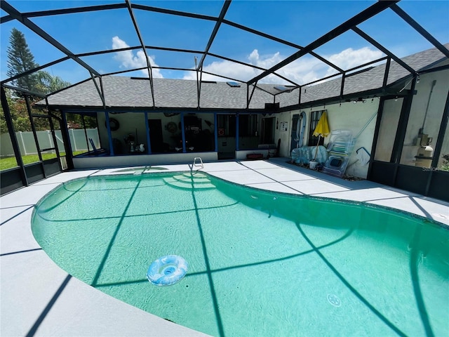 view of swimming pool featuring a patio area and a lanai