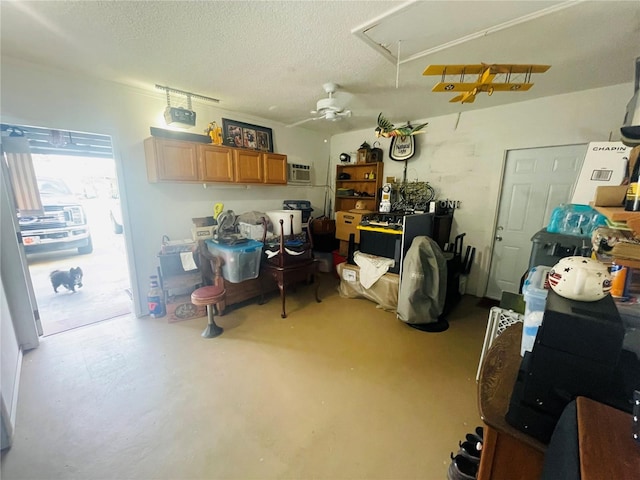 interior space with ceiling fan and a wall mounted air conditioner