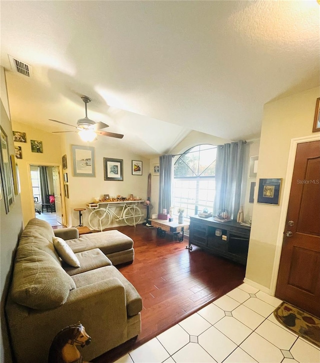 living room with light hardwood / wood-style flooring, ceiling fan, and lofted ceiling