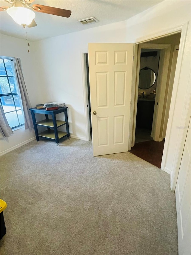 unfurnished bedroom featuring carpet and ceiling fan