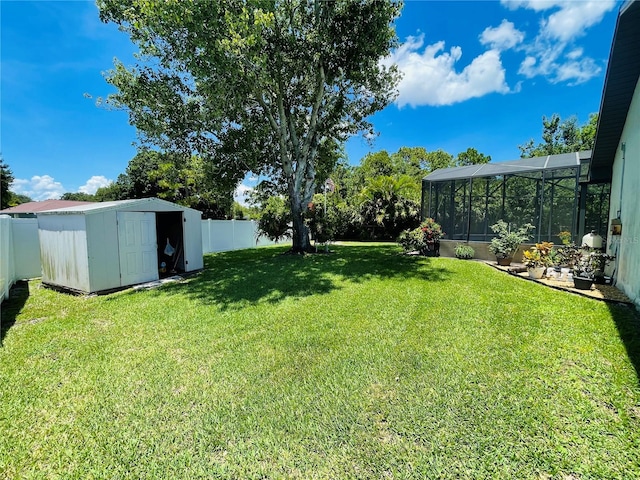 view of yard featuring a lanai and a storage shed