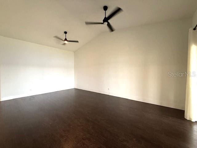 empty room with vaulted ceiling, dark wood-type flooring, and ceiling fan