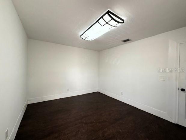 unfurnished room featuring hardwood / wood-style flooring