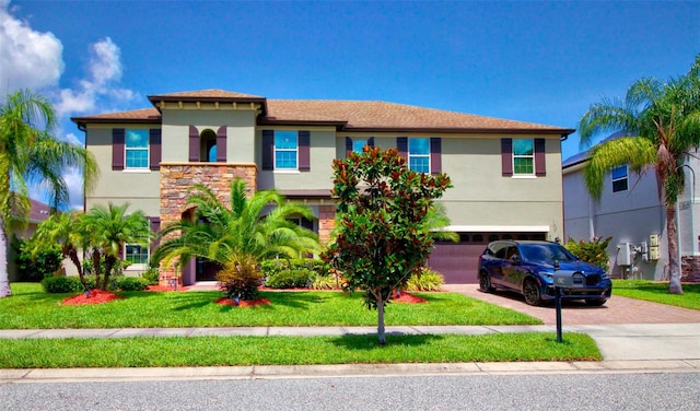 view of front of home with a garage and a front lawn