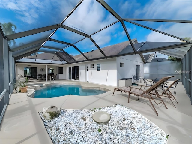 view of swimming pool with a patio and a lanai