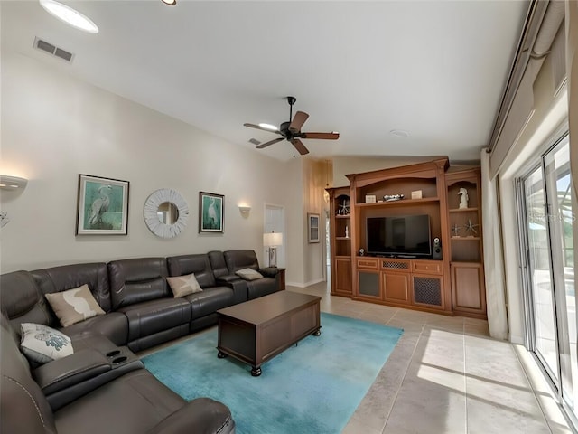 living room with vaulted ceiling, light tile patterned floors, and ceiling fan