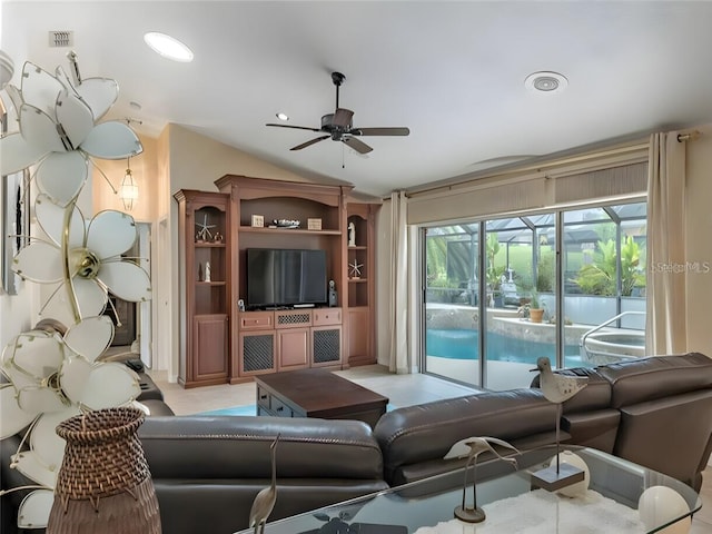 living room with ceiling fan and lofted ceiling