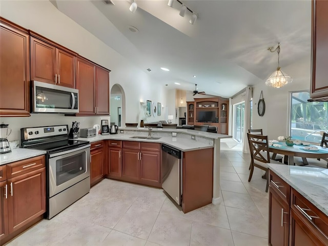 kitchen with stainless steel appliances, sink, kitchen peninsula, rail lighting, and ceiling fan with notable chandelier