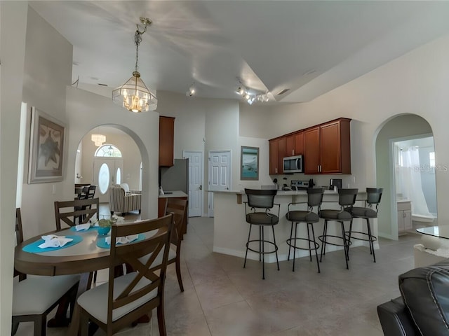 tiled dining space featuring a chandelier