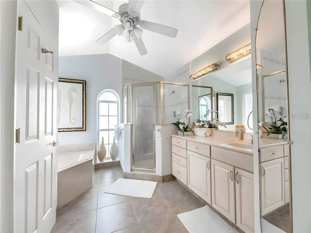 bathroom featuring plus walk in shower, vaulted ceiling, tile patterned flooring, vanity, and ceiling fan