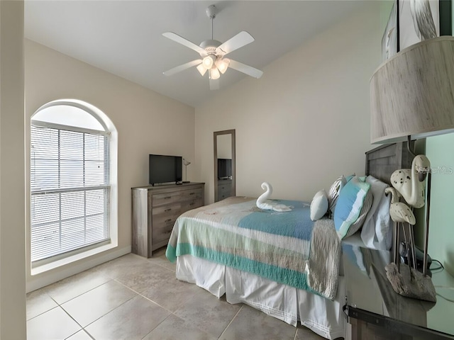 bedroom featuring light tile patterned floors, lofted ceiling, and ceiling fan