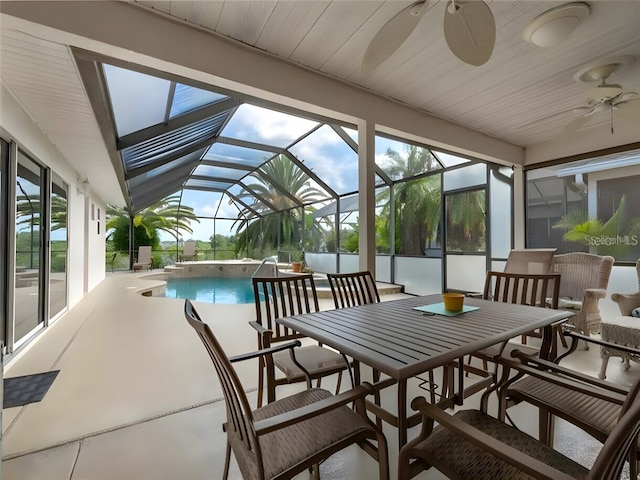 sunroom featuring ceiling fan, lofted ceiling, and plenty of natural light