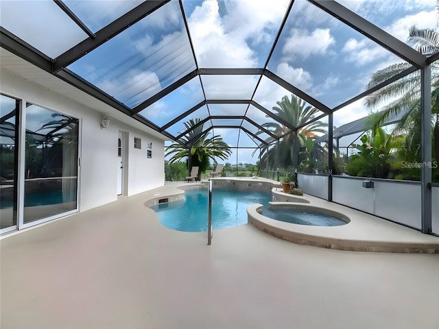 view of swimming pool featuring an in ground hot tub, a patio area, and a lanai