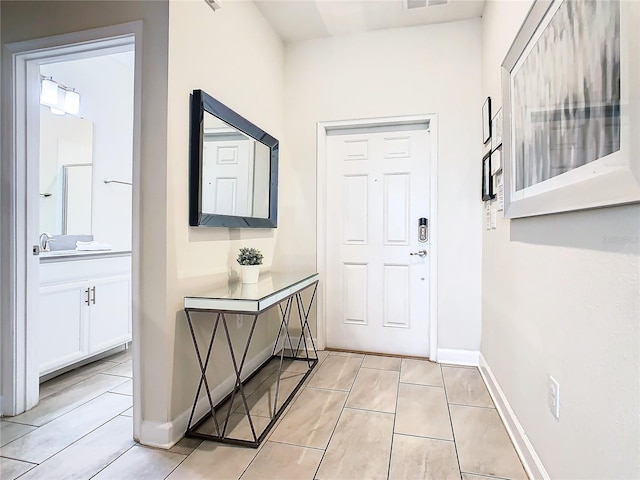 foyer featuring light tile patterned flooring