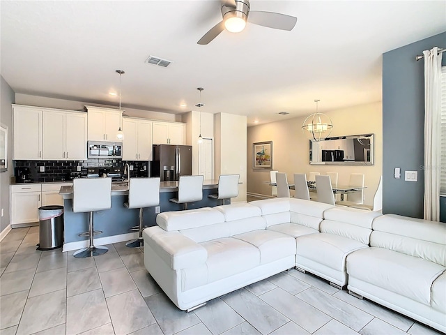 tiled living room featuring sink and ceiling fan