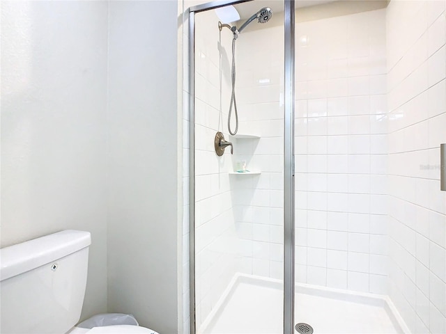 bathroom with walk in shower and toilet