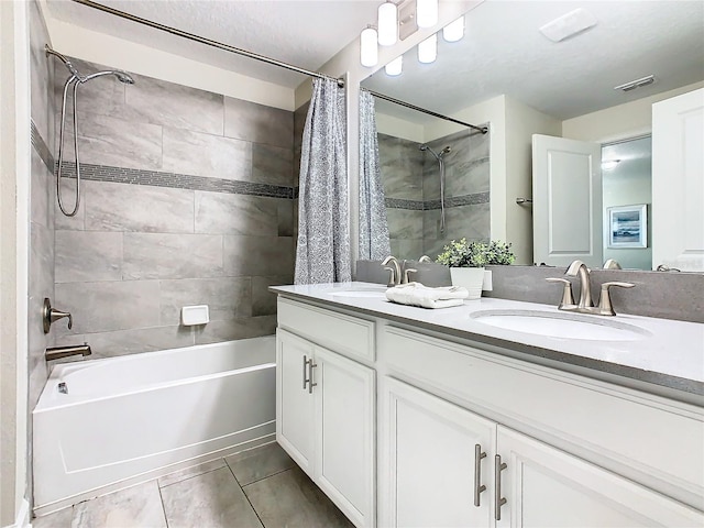 bathroom with shower / bathtub combination with curtain, tile patterned flooring, and double vanity