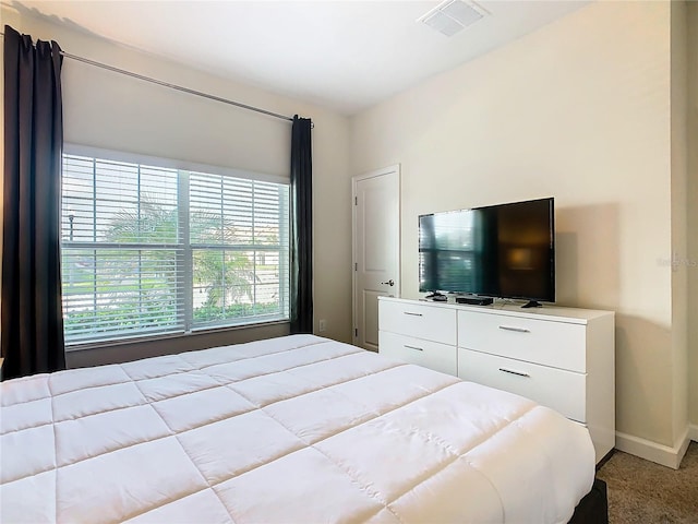 bedroom featuring light carpet