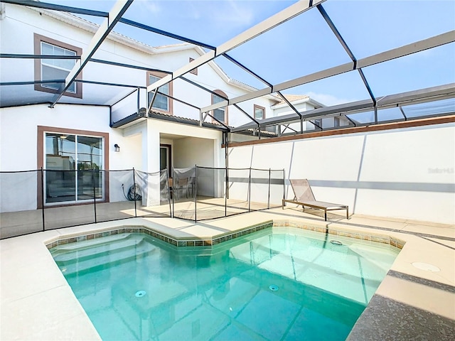 view of swimming pool with a lanai, a hot tub, and a patio