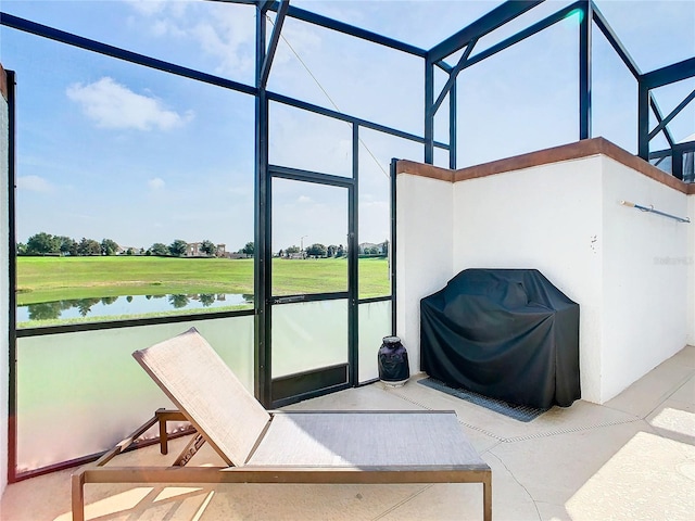 sunroom / solarium featuring a water view