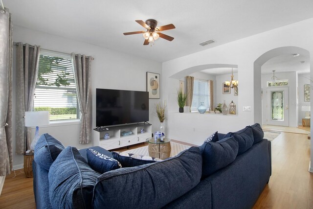 living room featuring wood-type flooring and ceiling fan