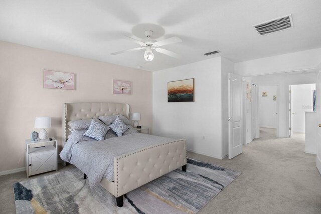 bedroom featuring light colored carpet and ceiling fan