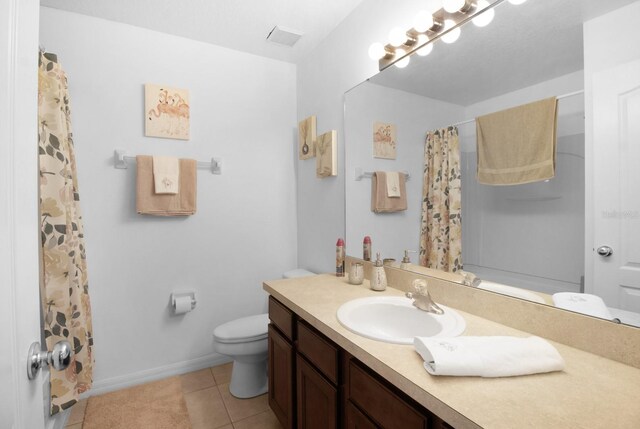 bathroom featuring vanity, tile patterned floors, and toilet