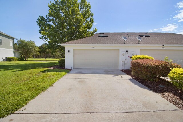 view of side of property with a garage and a lawn