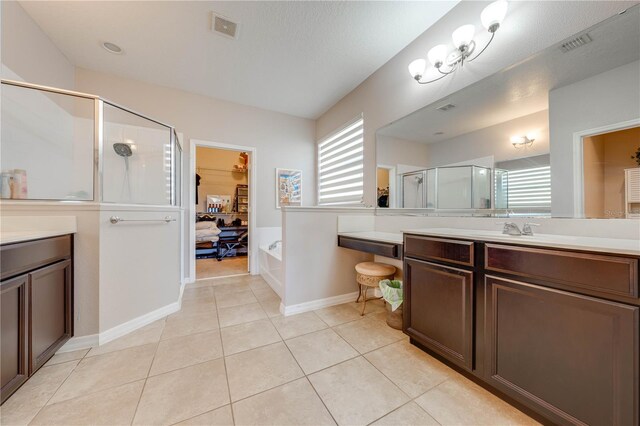 bathroom featuring vanity, tile patterned flooring, and separate shower and tub