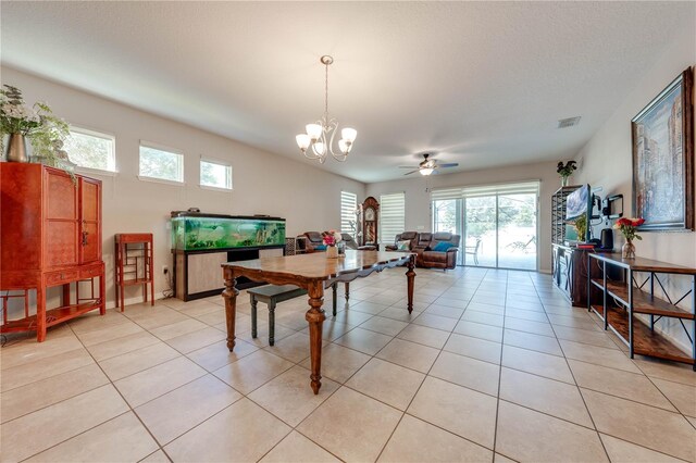 recreation room featuring light tile patterned flooring and ceiling fan with notable chandelier