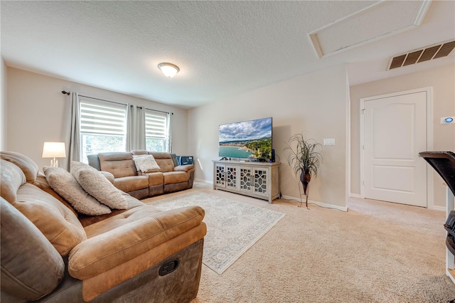 carpeted living room with a textured ceiling