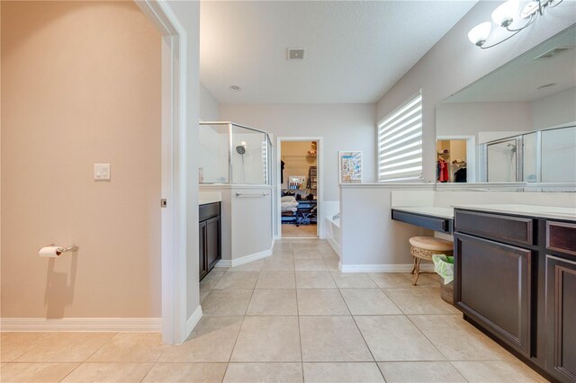 bathroom featuring independent shower and bath, vanity, and tile patterned floors