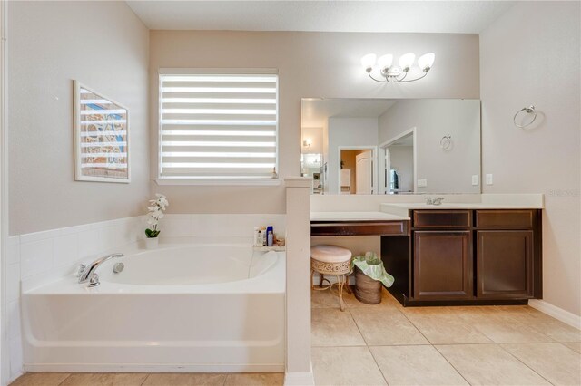 bathroom with tile patterned flooring, vanity, and a bathtub