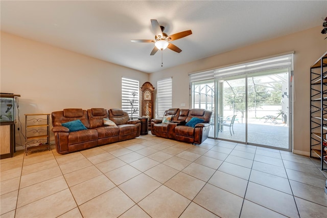 living room featuring ceiling fan, light tile patterned flooring, and plenty of natural light