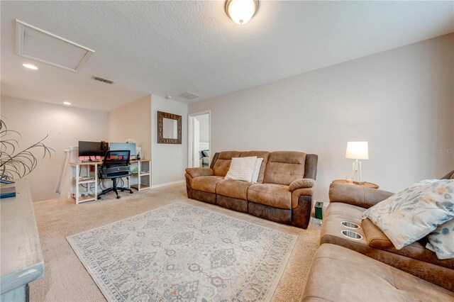 living room with light carpet and a textured ceiling