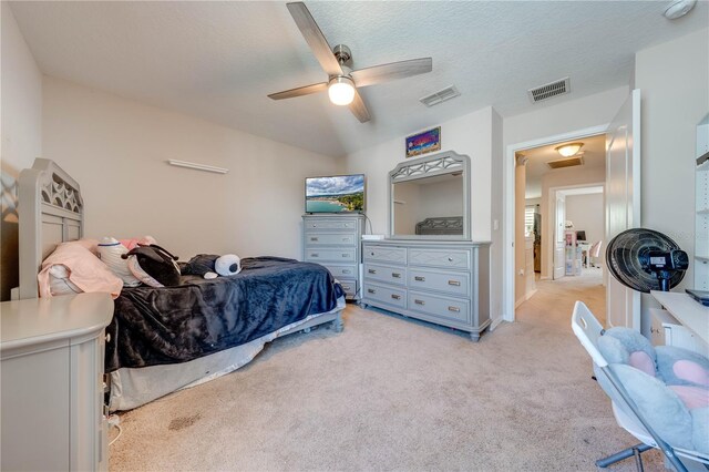 carpeted bedroom with a textured ceiling and ceiling fan