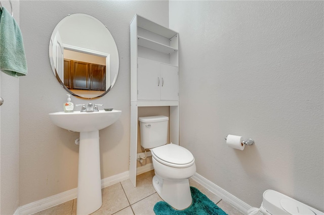 bathroom with toilet and tile patterned floors