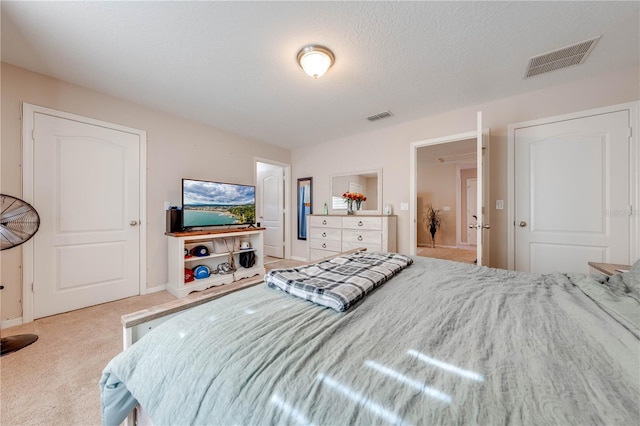 carpeted bedroom featuring a textured ceiling