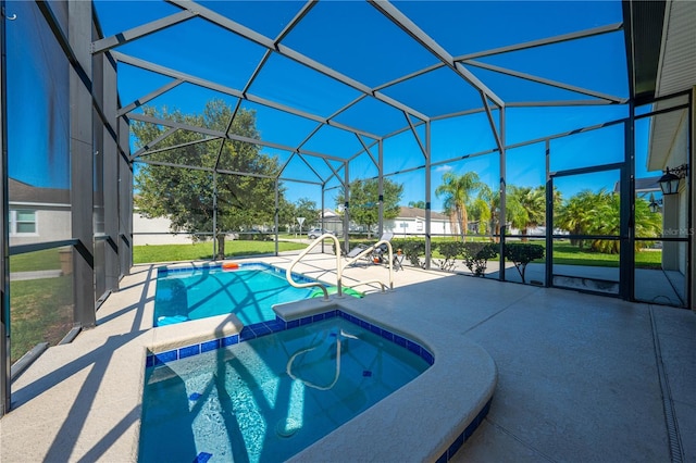 view of pool featuring an in ground hot tub, glass enclosure, and a patio area