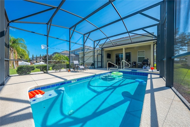 view of pool with a lanai and a patio