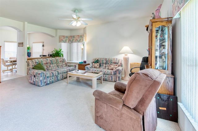 carpeted living room with ceiling fan