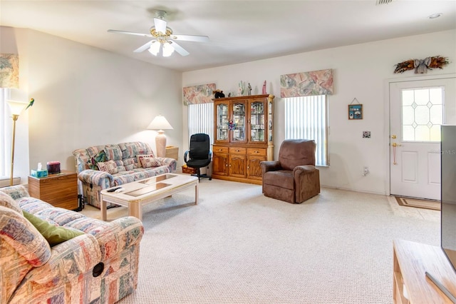 living room featuring carpet floors and ceiling fan