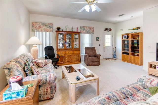 carpeted living room with ceiling fan