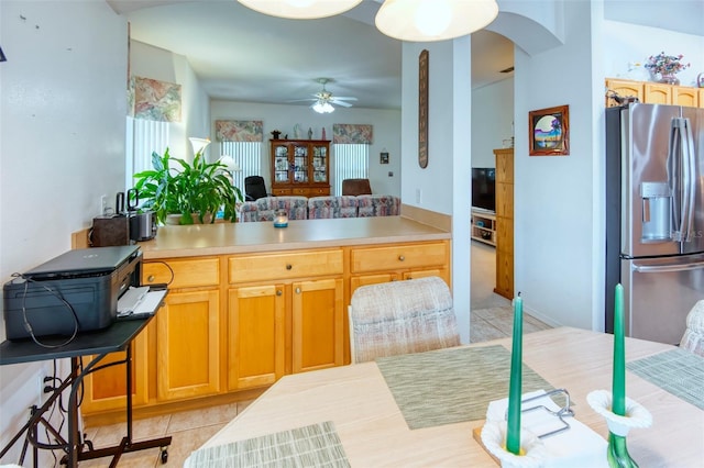 kitchen with stainless steel fridge, ceiling fan, and light tile patterned flooring