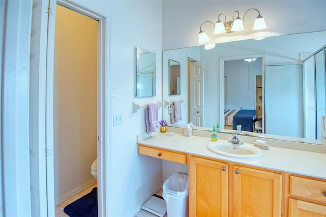 bathroom with walk in shower, vanity, toilet, and tile patterned flooring